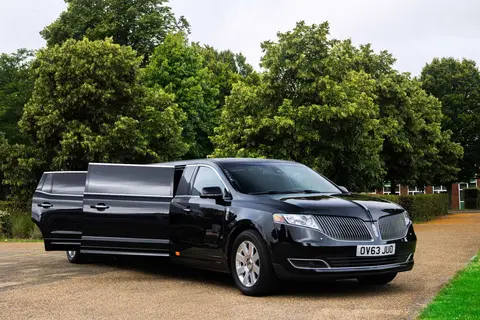 Black Lincoln MKT stretch limousine on a park driveway